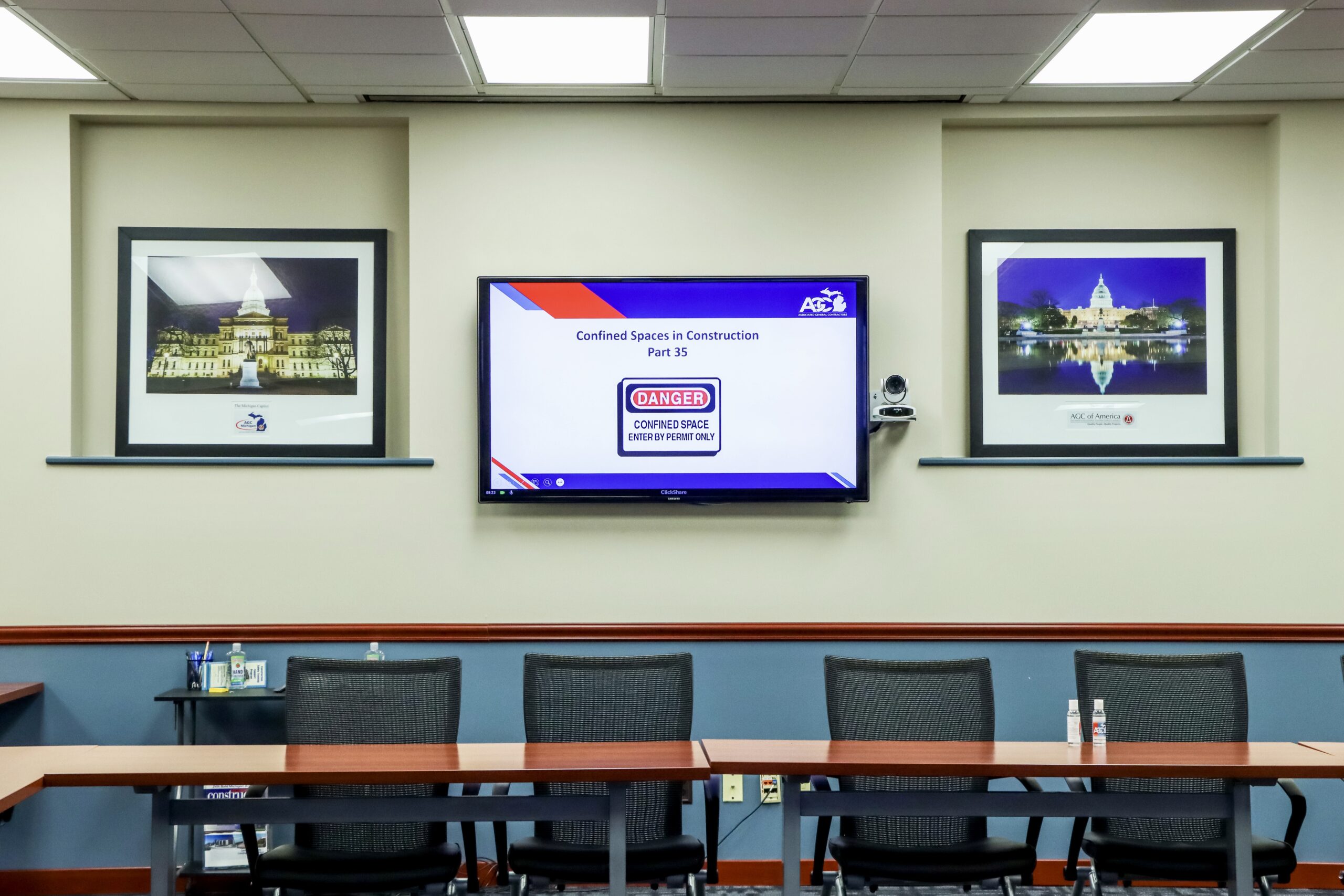display with video conferencing equipment showing a power point presentation.