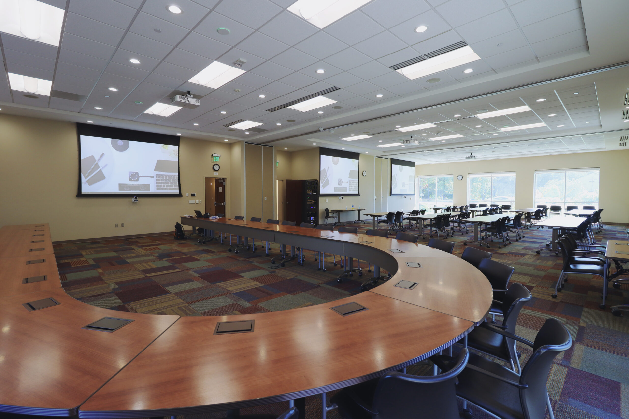 A very large conference space is opened up to show that all 3 rooms can be combined into one space and system. We are sitting on the Boardroom side looking over the table towards the other 2 spaces